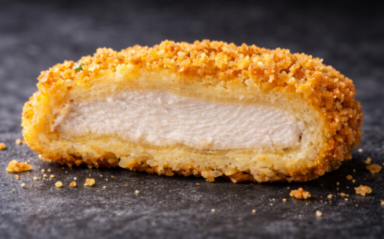 Macro cross section of a breaded nugget showing pre dust batter film and crumb layer